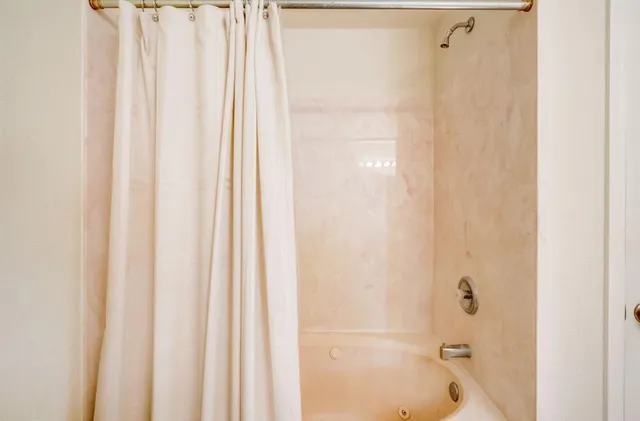 a spacious bathroom with a tub and shower