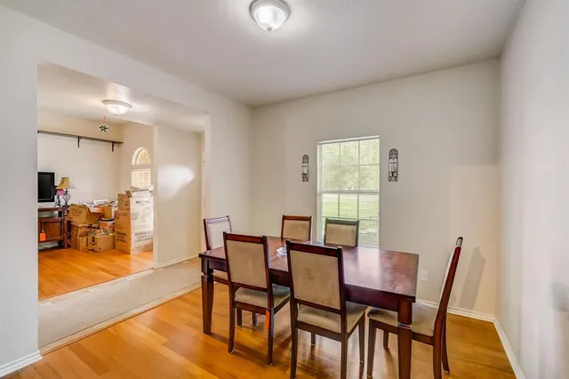 a view of a dining room with furniture wooden floor and a carpet