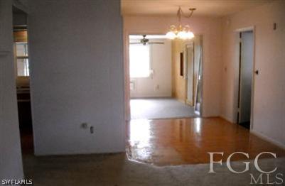 504 East Jasmine Road Lehigh Acres, FL 33936 - Photo 3 of 10 a view of a hallway with windows and chandelier