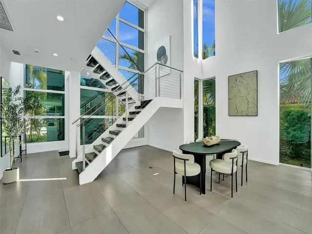 a living room with furniture wooden floor and a large window