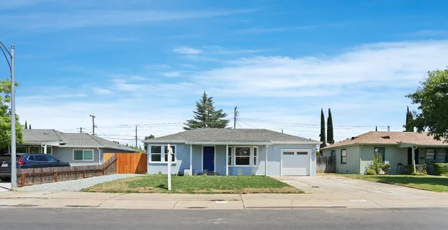 a front view of a house with a garden