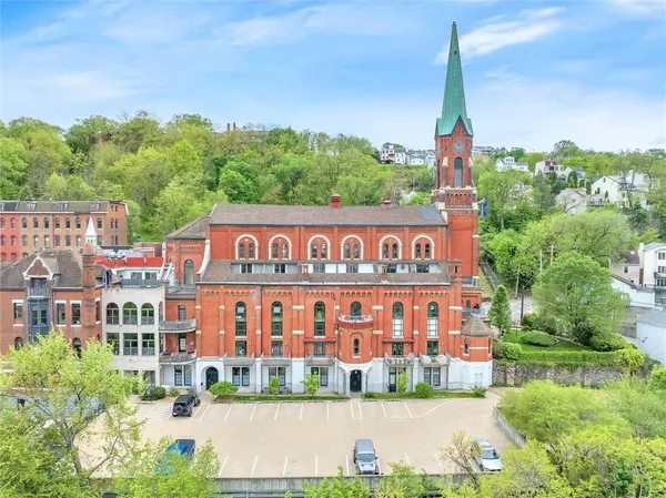 a kitchen with stainless steel appliances granite countertop a sink and a refrigerator