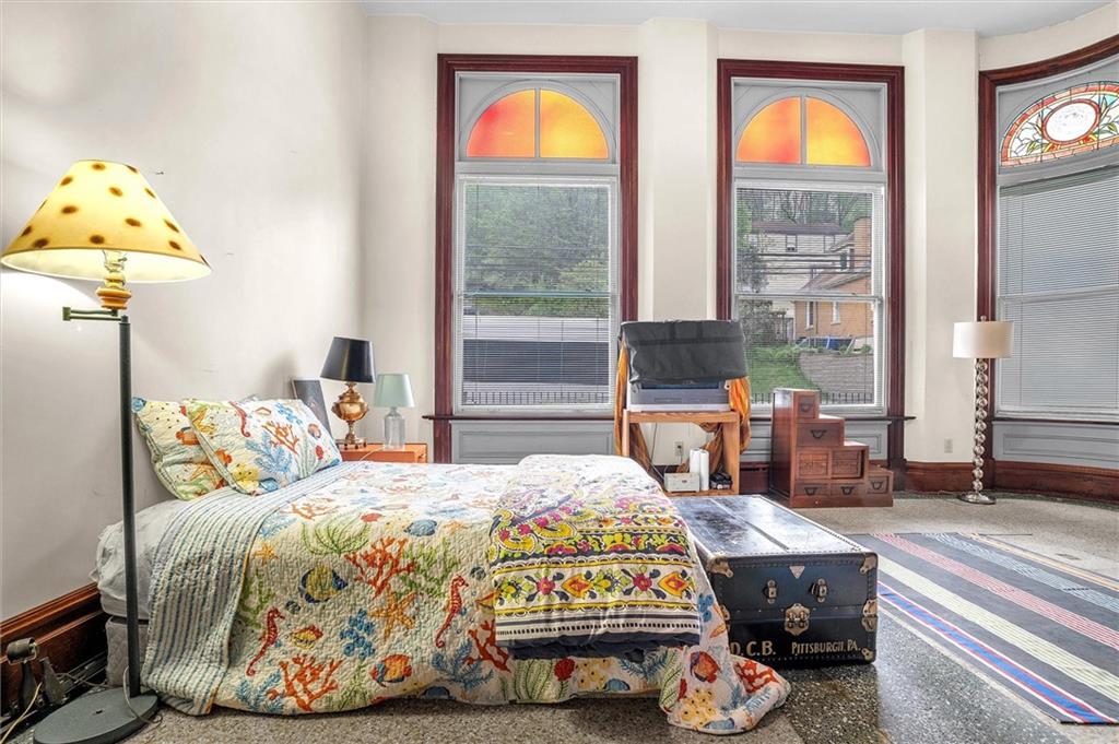 1 Pius Street, Unit B1 Pittsburgh, PA 15203 - Photo 25 of 45 a bedroom with a bed and a chandelier