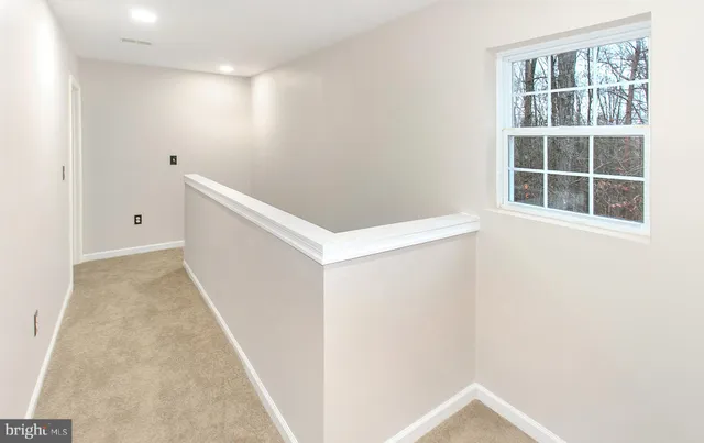 an entryway with wooden floor and windows