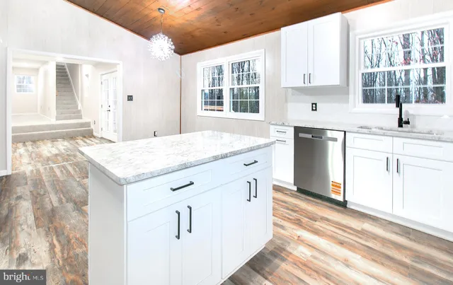 a kitchen that has a sink and a stove in it