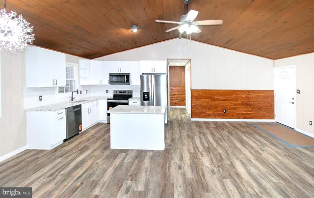 a view of a kitchen with microwave and cabinets