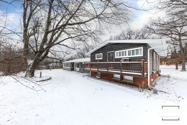 a view of a house with a snow in the yard