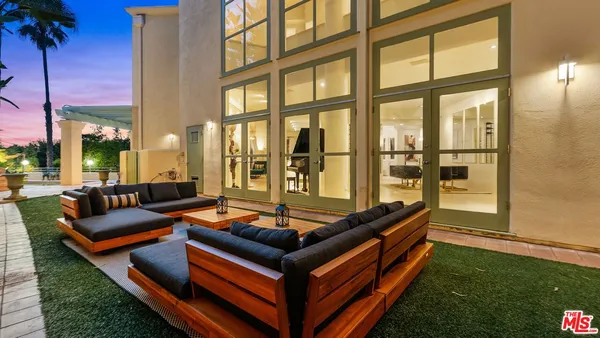 a living room with furniture and a floor to ceiling window