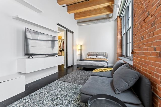 a bedroom with bed and balcony