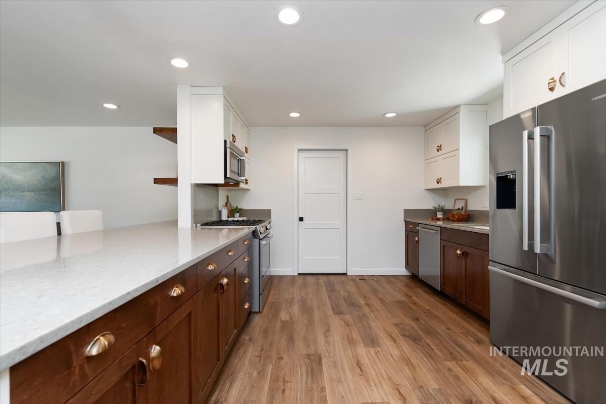 2217 North Middlefield Road Boise, ID 83704 - Photo 13 of 34 Modern kitchen featuring wood-finish flooring, recessed lighting, and a white three-panel interior door