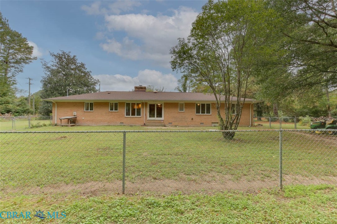 6822 Enfield Road Gloucester, VA 23061 - Photo 33 of 35 Rear view of property with brick siding, a fenced backyard, a chimney, crawl space, and entry steps
