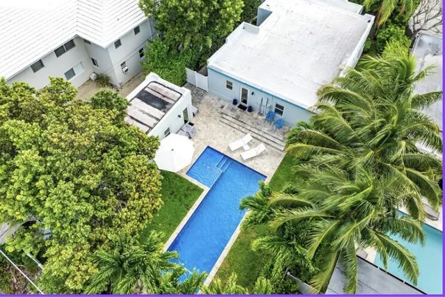an aerial view of a house with a yard