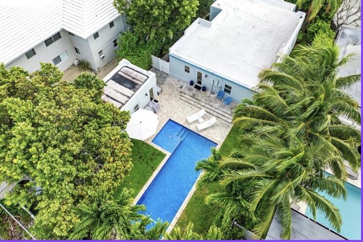 an aerial view of a house with a yard