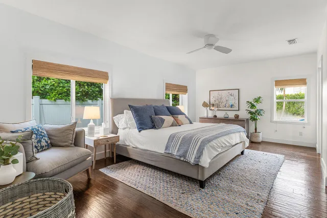 a bedroom with a bed couch and a window