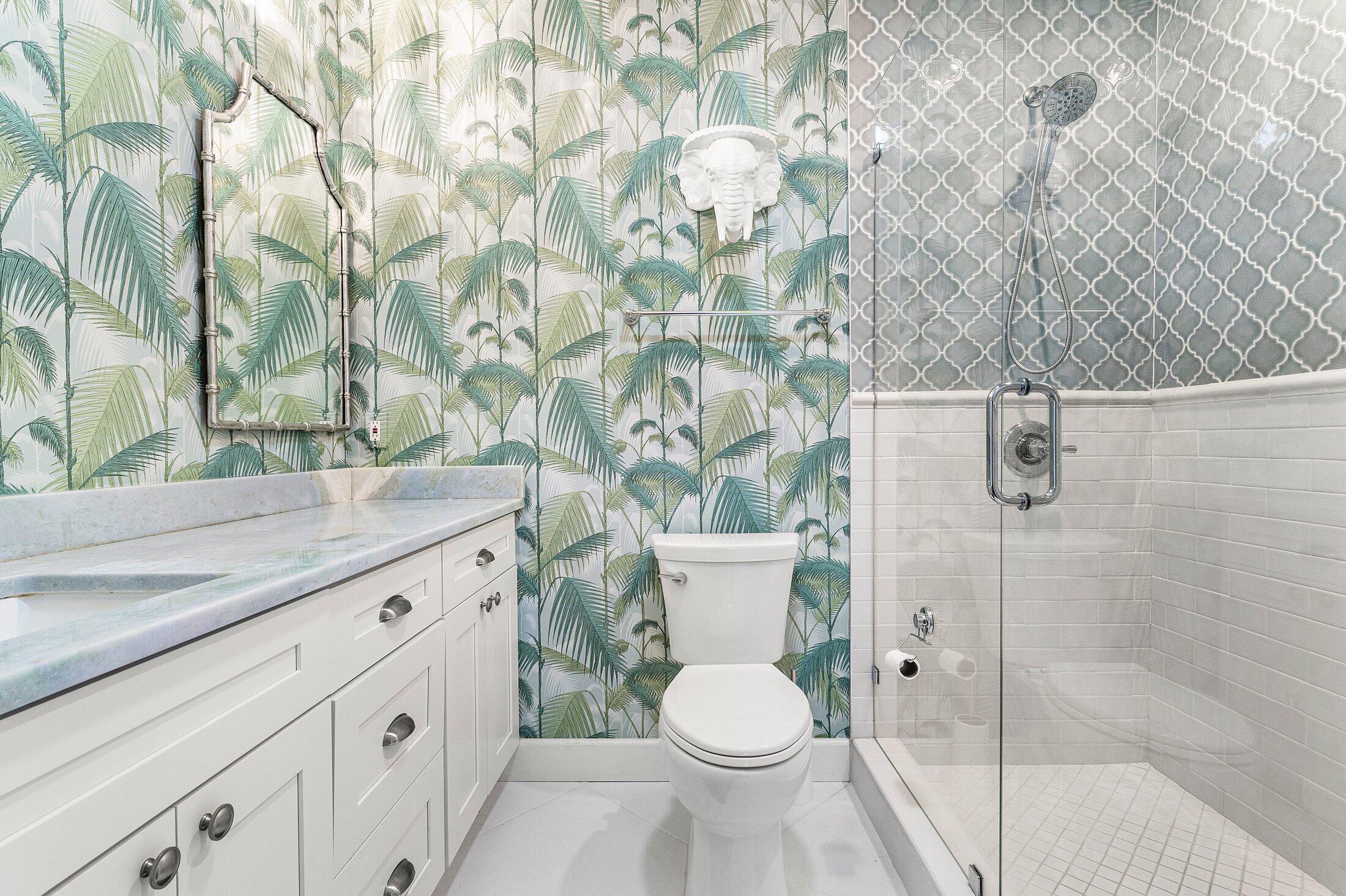 414 Northeast 7th Avenue Delray Beach, FL 33483 - Photo 14 of 29 a bathroom with a granite countertop toilet and a sink