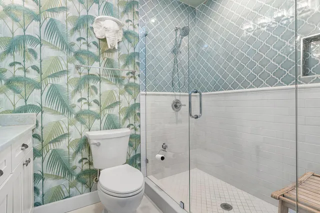 a bathroom with a toilet and a shower