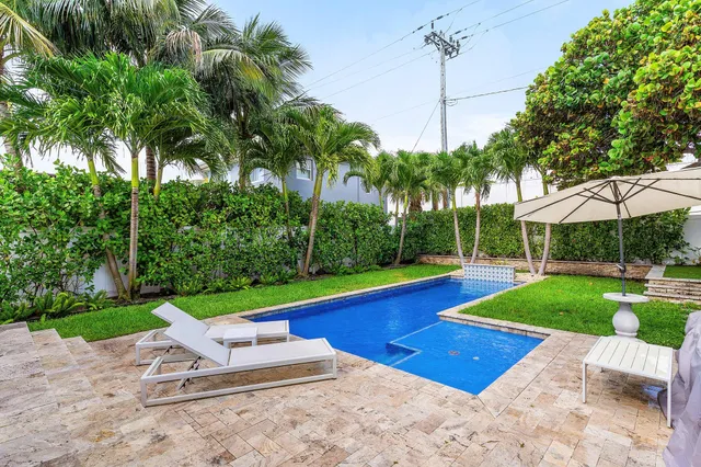 a swimming pool with outdoor seating and yard