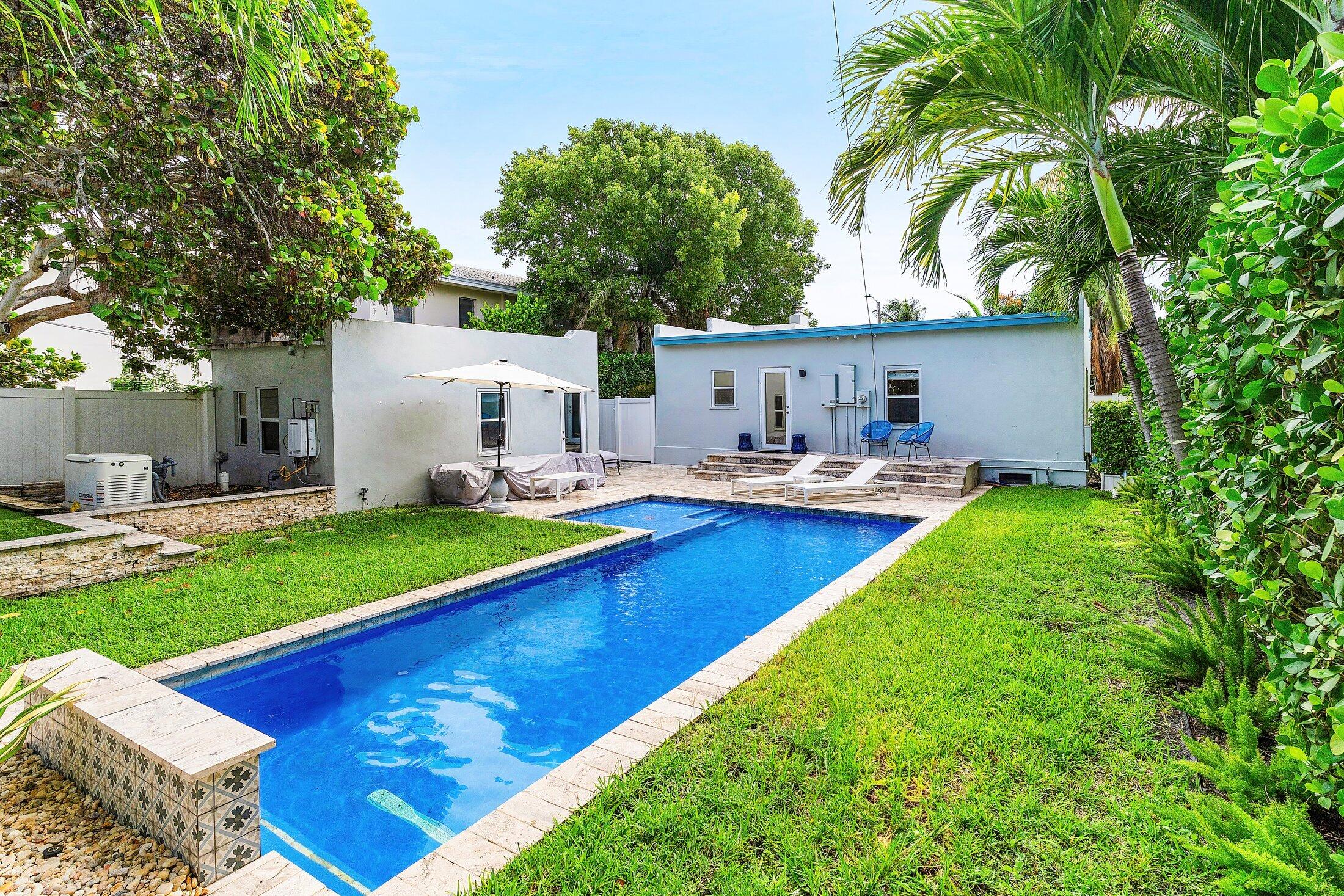414 Northeast 7th Avenue Delray Beach, FL 33483 - Photo 23 of 29 a swimming pool with outdoor seating and yard