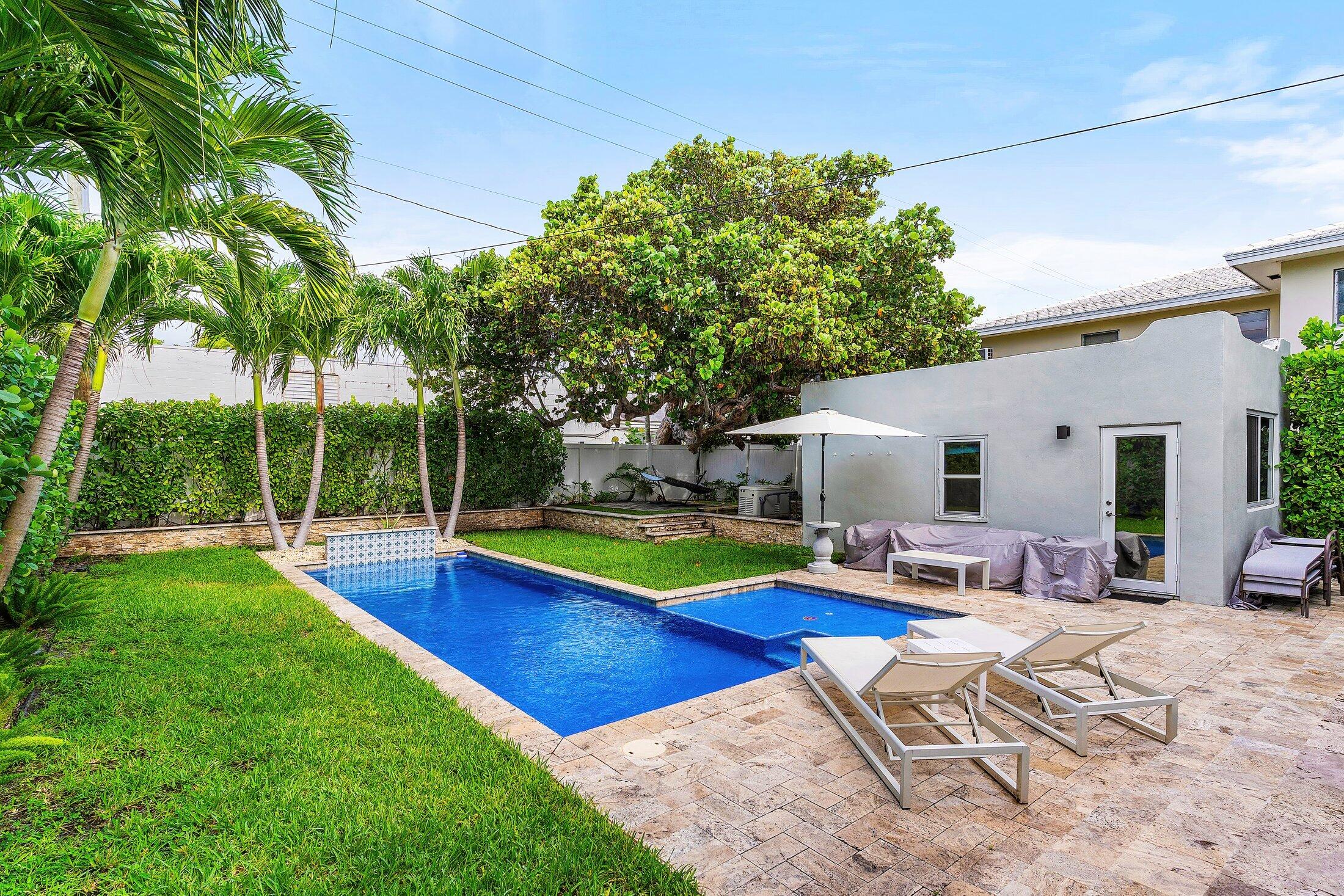 414 Northeast 7th Avenue Delray Beach, FL 33483 - Photo 24 of 29 a view of pool with lawn chairs and plants