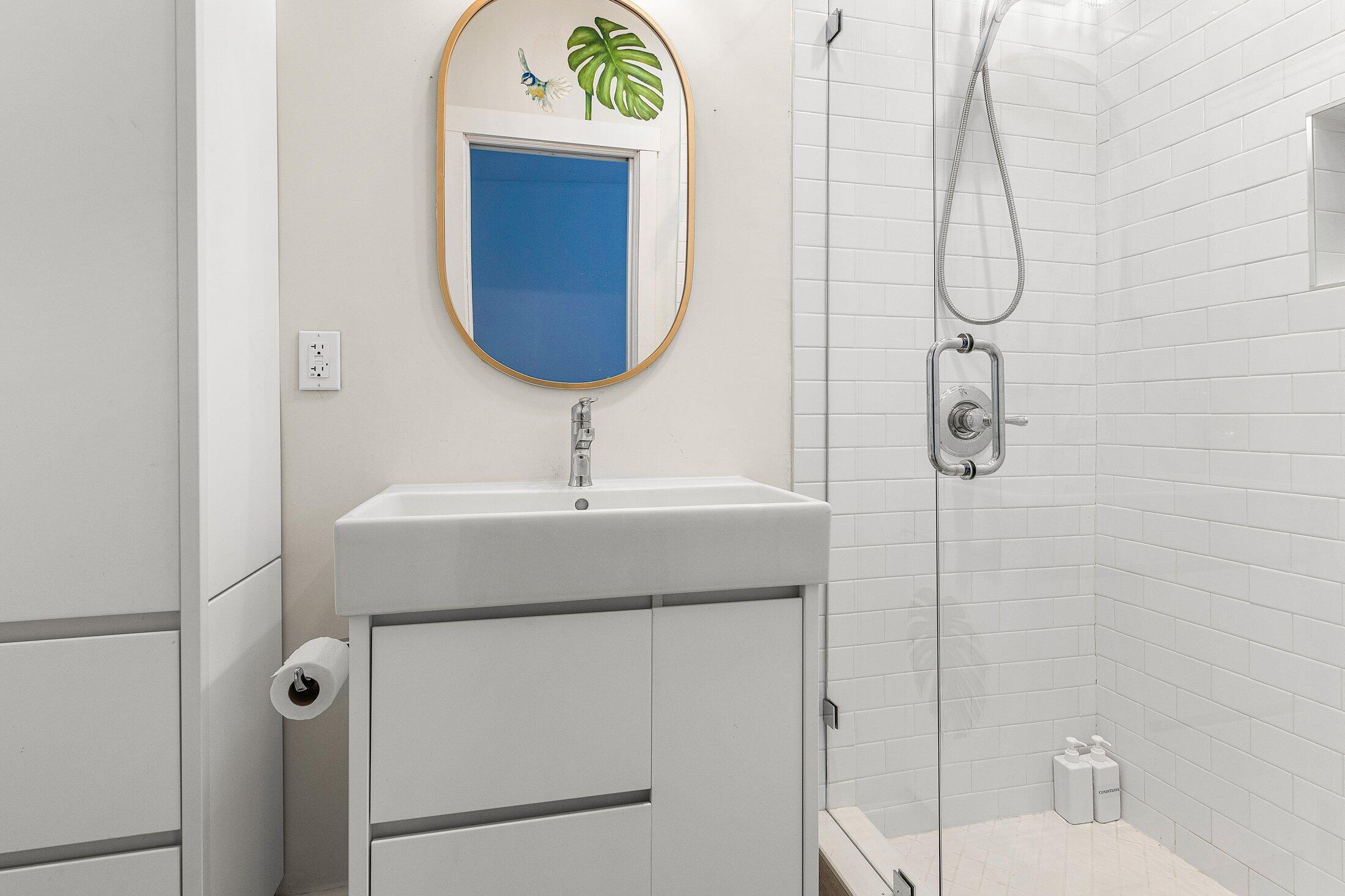 414 Northeast 7th Avenue Delray Beach, FL 33483 - Photo 27 of 29 a bathroom with a sink and mirror