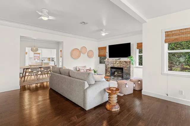 a living room with furniture a fireplace and a flat screen tv