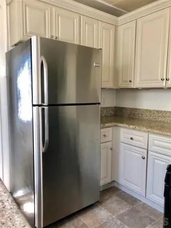 a white refrigerator freezer sitting in a kitchen