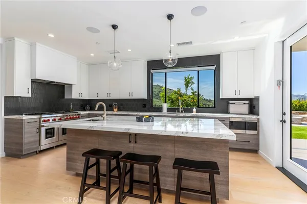 a kitchen with counter top space cabinets and appliances