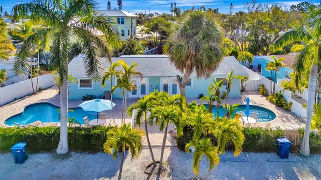 a view of a multi story residential apartment building with a yard and potted plants
