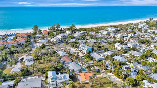 an aerial view of a houses with a yard