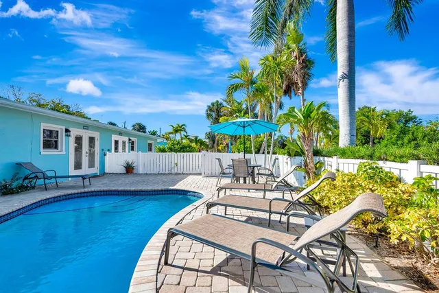 a view of a backyard with plants and patio