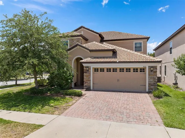a front view of a house with a yard and garage