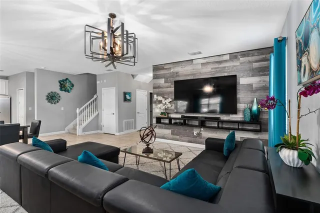 a living room with furniture and a flat screen tv