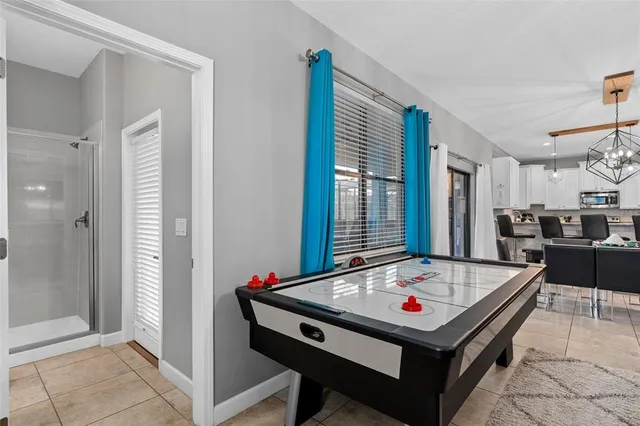 a room with pool table and windows