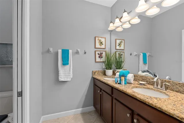 a bathroom with a granite countertop sink a mirror and vanity
