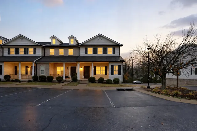 a front view of a building with a yard