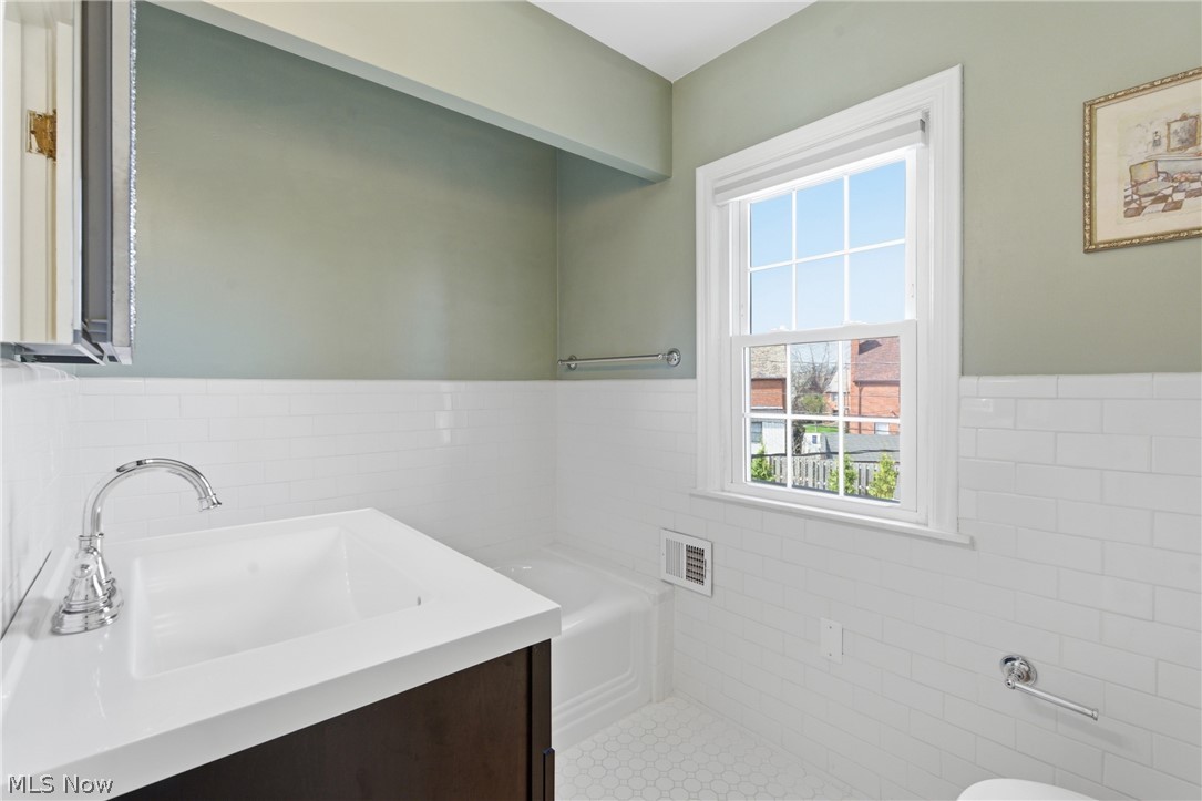 2552 Channing Road Cleveland, OH 44118 - Photo 18 of 33 Second floor full bathroom featuring white tile, soaking tub and updated vanity.
