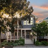 a front view of a house with a tree