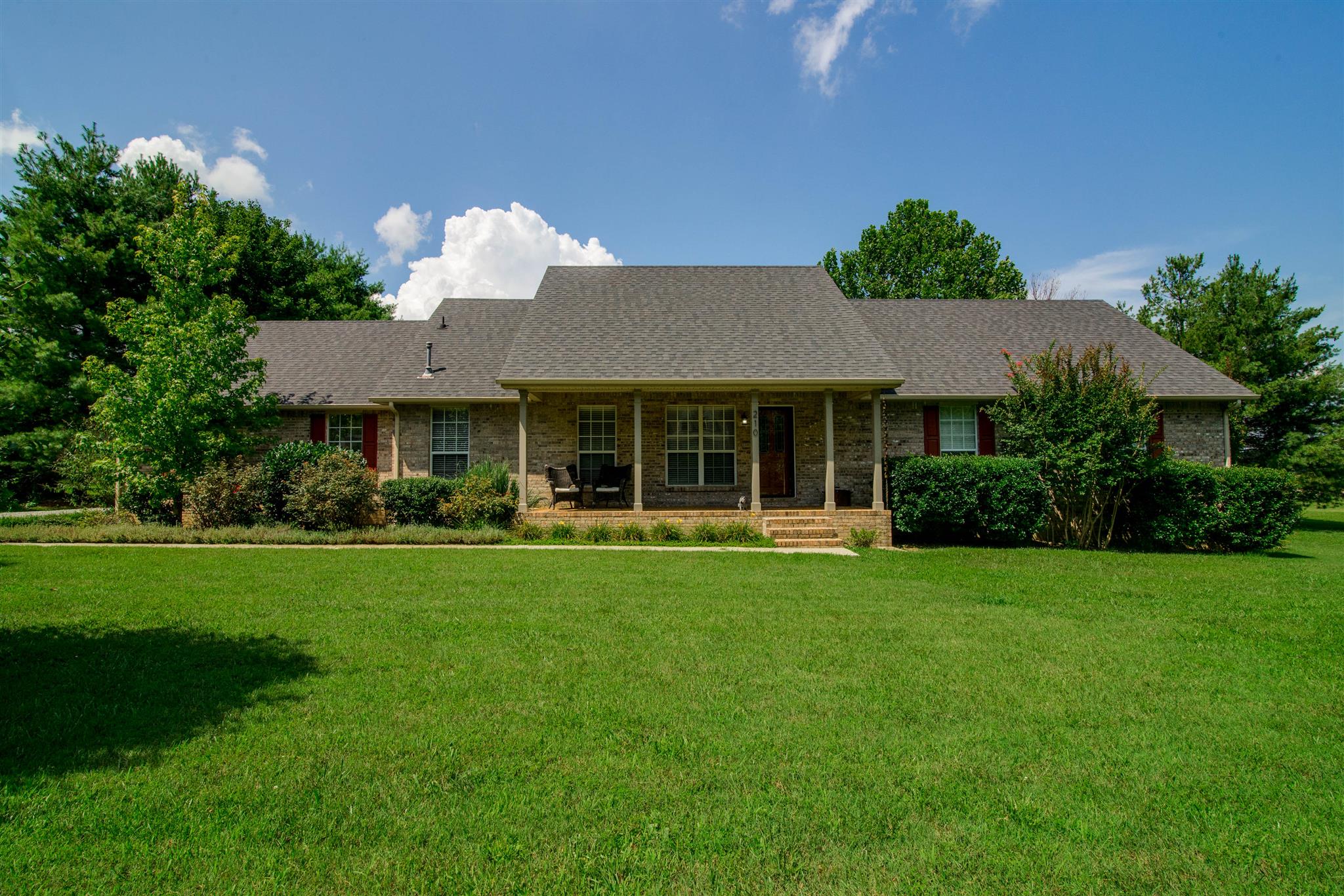 210 Independence Street Springfield, TN 37172 - Photo 1 of 30 a front view of a house with a yard and porch