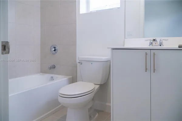 a white toilet sitting next to a bath tub