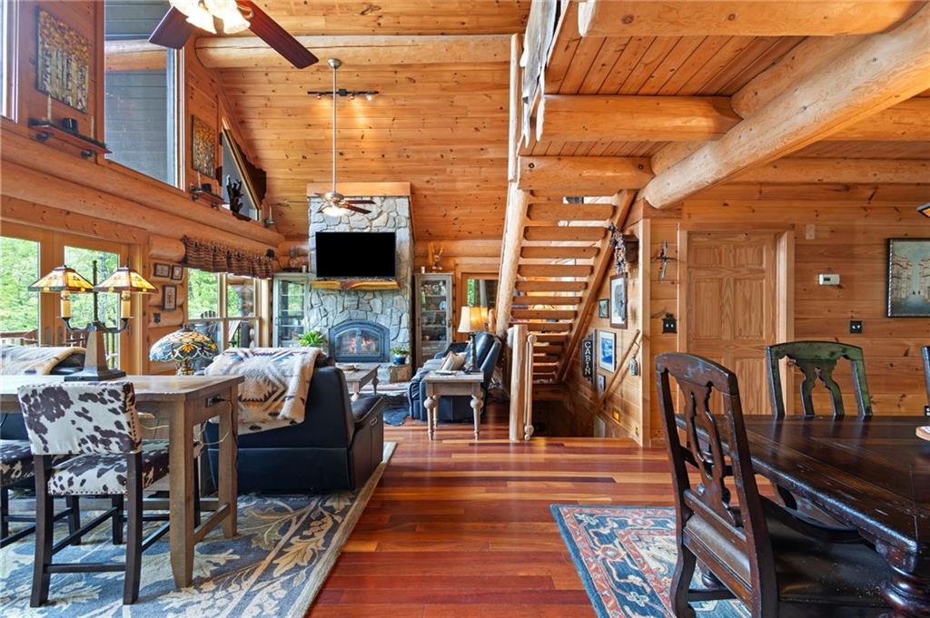 103 Twin Lakes Road Blue Ridge, GA 30513 - Photo 13 of 71 a view of a patio with table and chairs couches flat tv and wooden floor