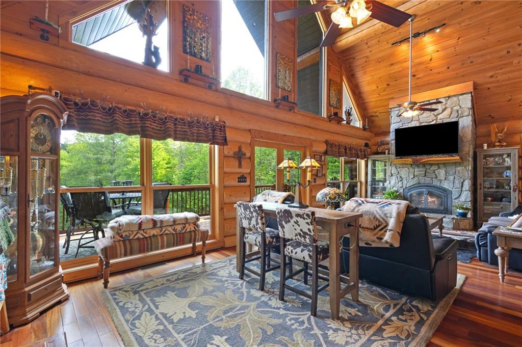 103 Twin Lakes Road Blue Ridge, GA 30513 - Photo 14 of 71 a view of a patio with table and chairs potted plants with floor to ceiling window