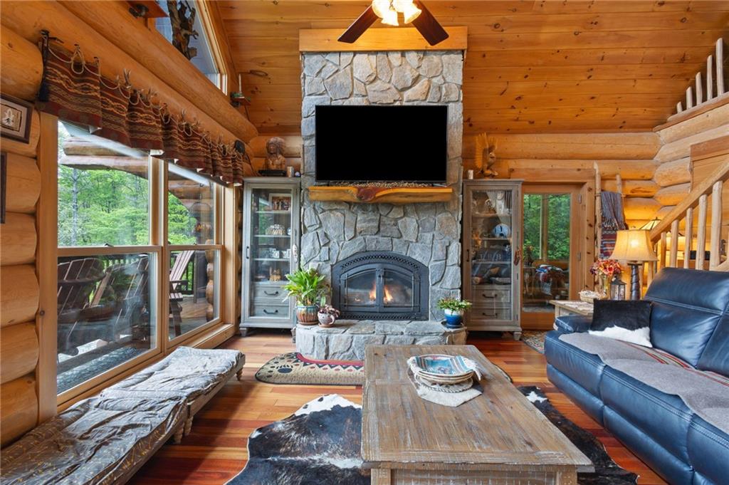 103 Twin Lakes Road Blue Ridge, GA 30513 - Photo 16 of 71 a living room with furniture a flat screen tv and a fireplace