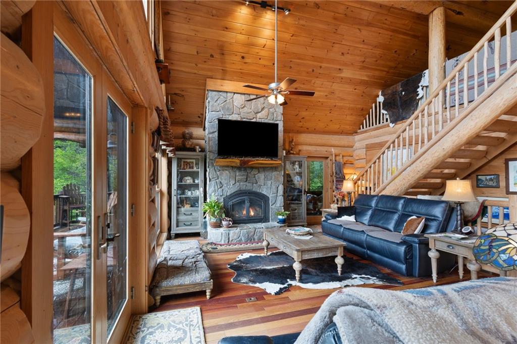 103 Twin Lakes Road Blue Ridge, GA 30513 - Photo 17 of 71 a living room with furniture a fireplace and a flat screen tv