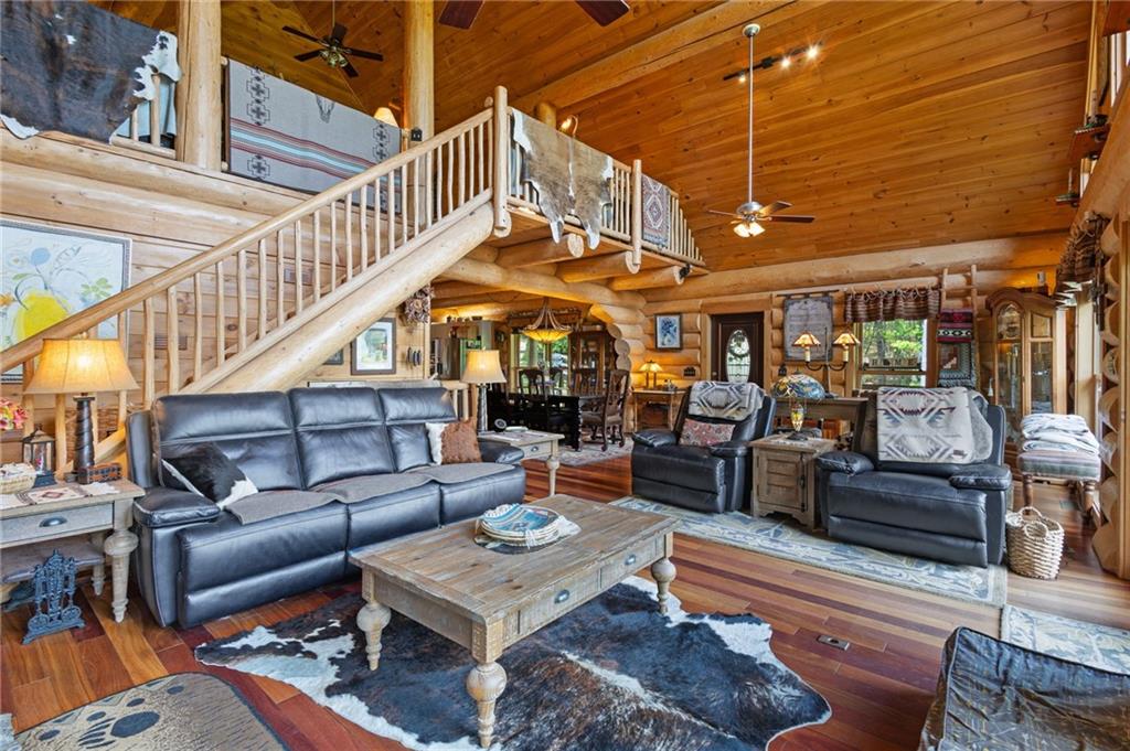 103 Twin Lakes Road Blue Ridge, GA 30513 - Photo 19 of 71 a living room with furniture a ceiling fan and a rug