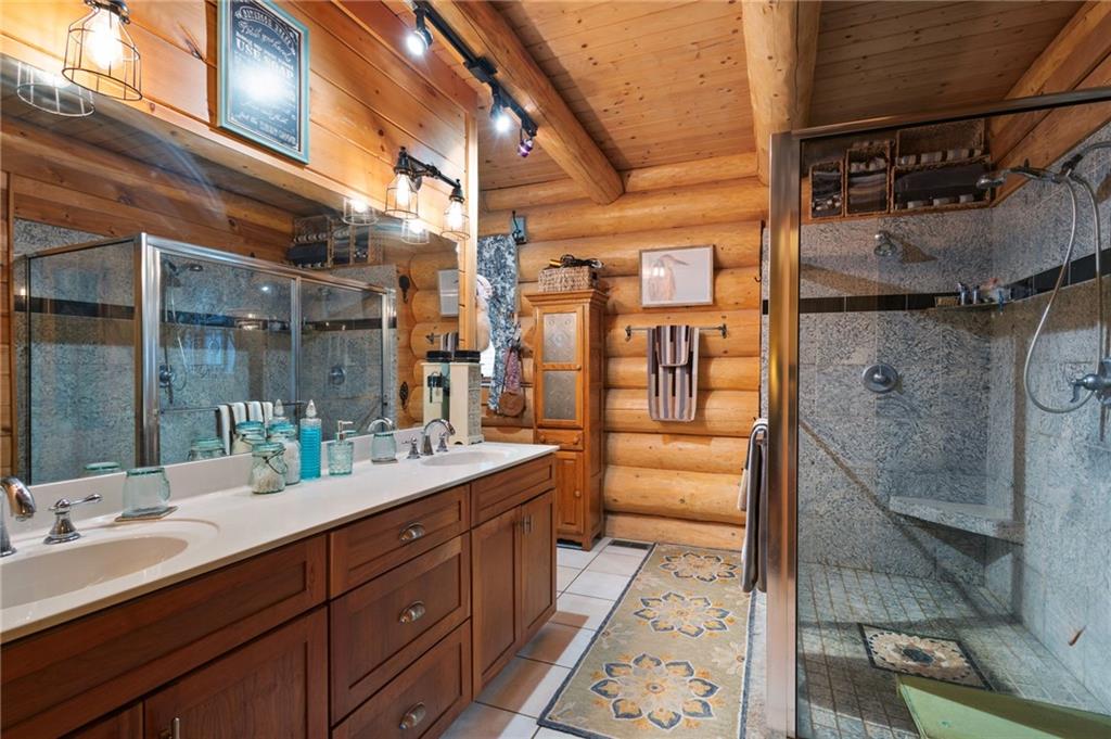 103 Twin Lakes Road Blue Ridge, GA 30513 - Photo 29 of 71 a bathroom with a double vanity sink toilet and shower