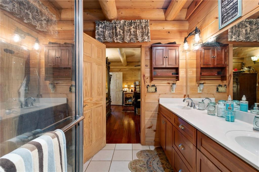 103 Twin Lakes Road Blue Ridge, GA 30513 - Photo 31 of 71 a bathroom with a sink double vanity and a mirror