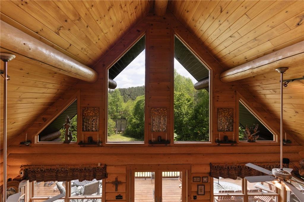 103 Twin Lakes Road Blue Ridge, GA 30513 - Photo 36 of 71 a view of a house with a balcony and floor to ceiling windows with wooden walls
