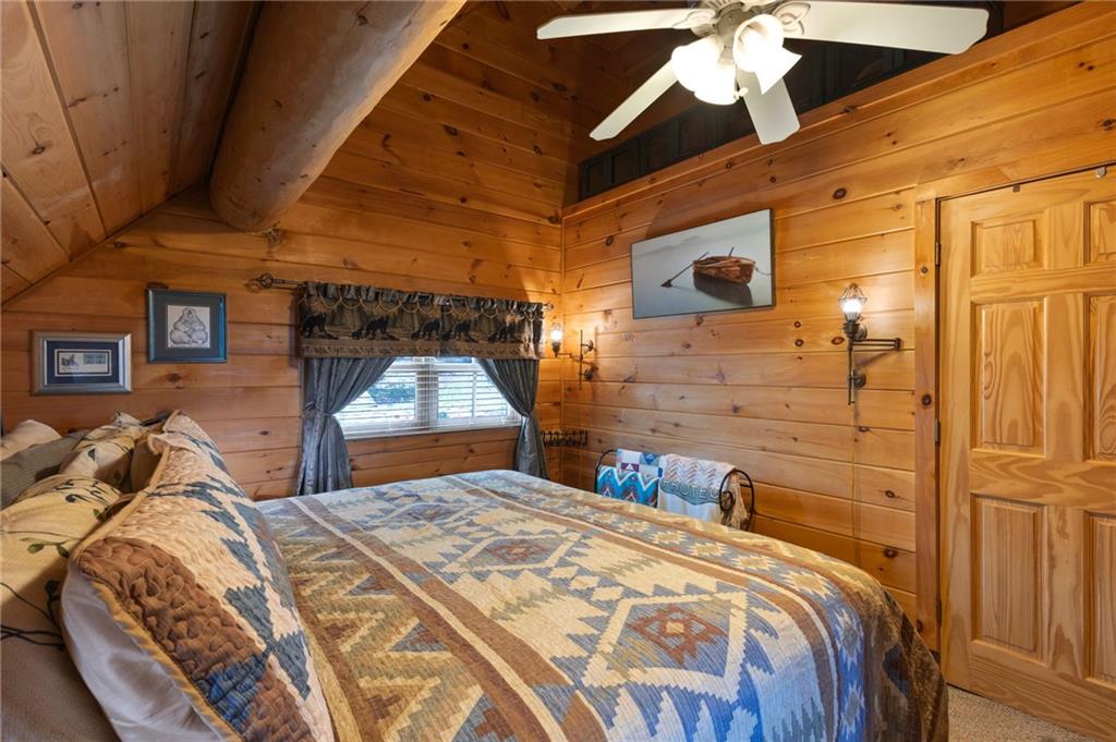 103 Twin Lakes Road Blue Ridge, GA 30513 - Photo 42 of 71 a bed sitting in a bedroom next to a window