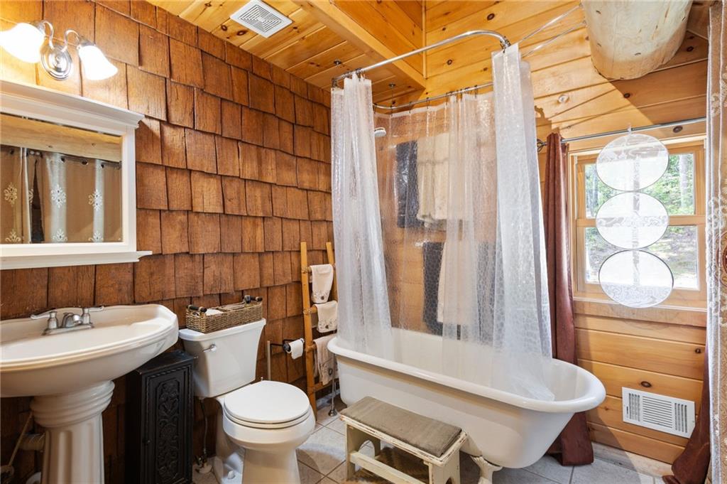 103 Twin Lakes Road Blue Ridge, GA 30513 - Photo 44 of 71 a bathroom with a sink toilet and shower