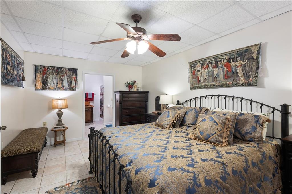 103 Twin Lakes Road Blue Ridge, GA 30513 - Photo 49 of 71 a bedroom with a large bed and a chandelier